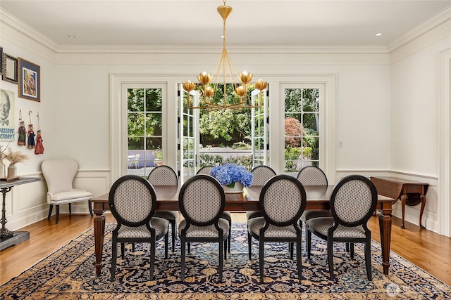 2001 Broadmoor Dr E, Seattle, WA 98112 - dining room featuring healthy amount of natural light, wood finished floors, ornamental molding, a chandelier, and a decorative wall