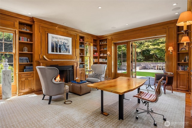2001 Broadmoor Dr E, Seattle, WA 98112 - office area with built in shelves, wood walls, a lit fireplace, and wood finished floors