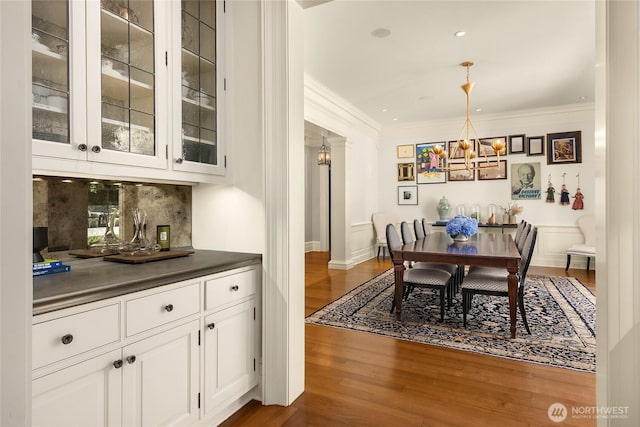 2001 Broadmoor Dr E, Seattle, WA 98112 - dining space featuring a chandelier, dark wood-type flooring, and crown molding
