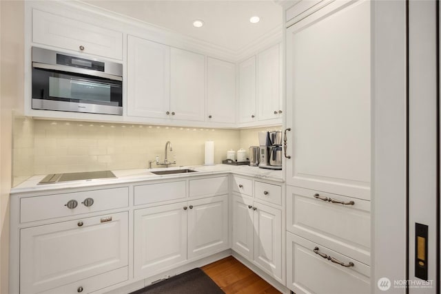 2001 Broadmoor Dr E, Seattle, WA 98112 - kitchen featuring black electric stovetop, light countertops, white cabinets, tasteful backsplash, and recessed lighting