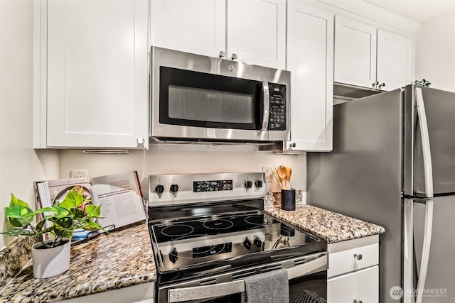 502 141st Ave SE Unit 45, Bellevue, WA 98007 - kitchen featuring stainless steel appliances, white cabinetry, and light stone counters