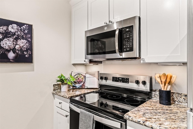 502 141st Ave SE Unit 45, Bellevue, WA 98007 - kitchen featuring stainless steel appliances, white cabinetry, and light stone countertops