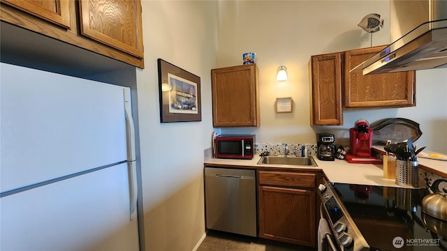 835 Ocean Shores Blvd NW Unit 305, Ocean Shores, WA 98569 - kitchen featuring stainless steel appliances, wall chimney range hood, light countertops, and brown cabinetry