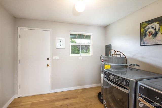 110 Victoria View St, Sequim, WA 98382 - laundry area featuring light wood finished floors, independent washer and dryer, and water heater