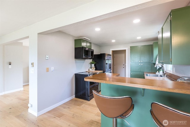 110 Victoria View St, Sequim, WA 98382 - kitchen with green cabinets, stainless steel microwave, smart refrigerator, a peninsula, and light wood-style floors