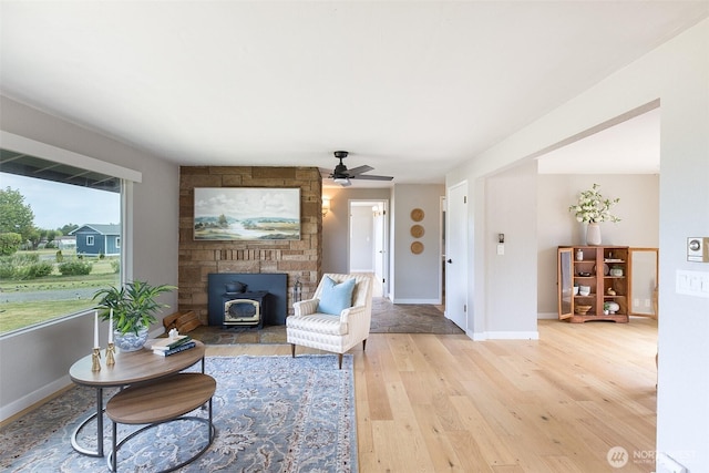 110 Victoria View St, Sequim, WA 98382 - living area featuring a wood stove, light wood-style floors, and ceiling fan