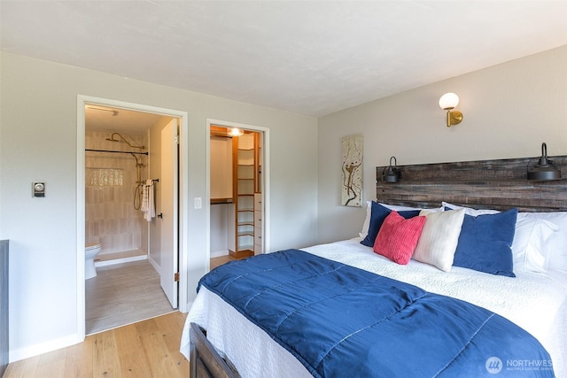 110 Victoria View St, Sequim, WA 98382 - bedroom with light wood-type flooring, ensuite bathroom, and a spacious closet