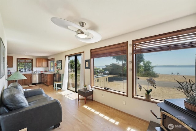 27523 SW Sandy Shores Dr, Vashon, WA 98070 - living room featuring light wood-type flooring, healthy amount of natural light, and a water view