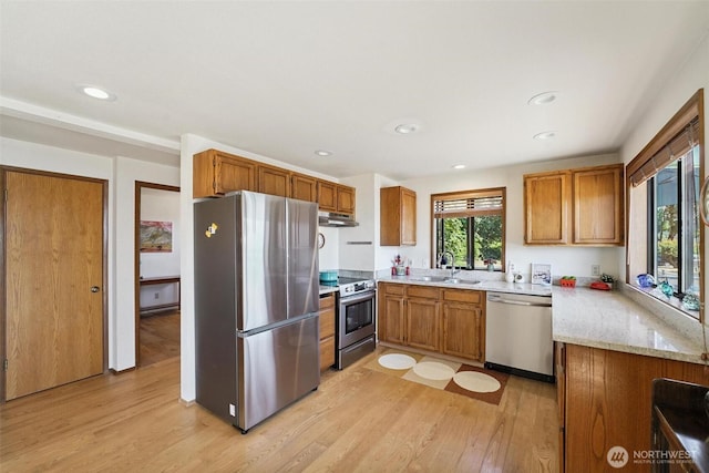 27523 SW Sandy Shores Dr, Vashon, WA 98070 - kitchen with appliances with stainless steel finishes, under cabinet range hood, light wood-style floors, brown cabinetry, and recessed lighting