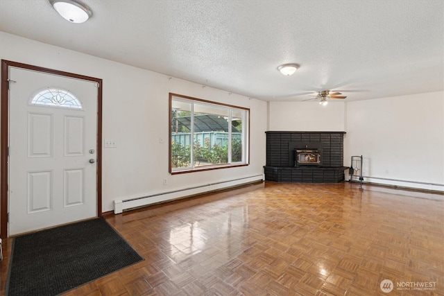 2598 25th Loop SE, Lacey, WA 98503 - entrance foyer featuring baseboard heating, ceiling fan, plenty of natural light, a textured ceiling, and a fireplace