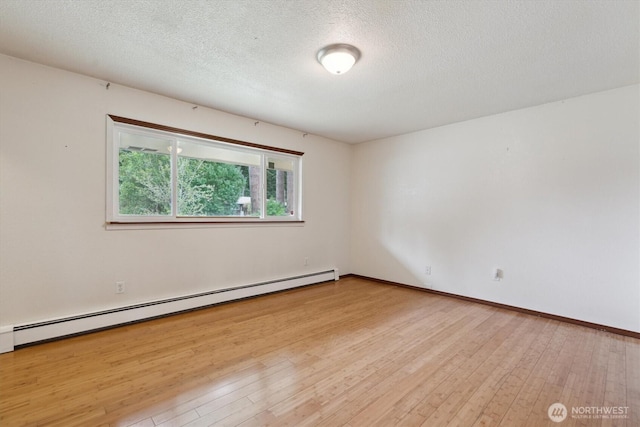 2598 25th Loop SE, Lacey, WA 98503 - spare room with baseboard heating, hardwood / wood-style floors, and a textured ceiling