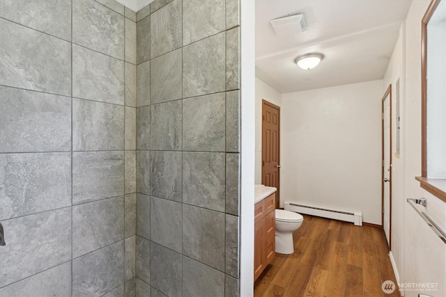2598 25th Loop SE, Lacey, WA 98503 - full bathroom featuring a baseboard radiator, wood finished floors, vanity, and a tile shower
