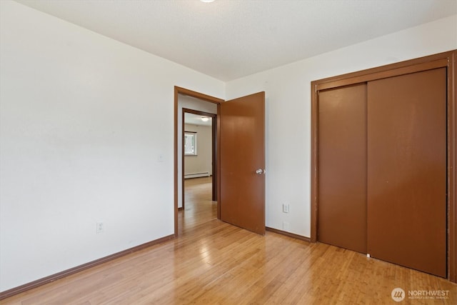 2598 25th Loop SE, Lacey, WA 98503 - unfurnished bedroom featuring baseboard heating, light wood-style floors, and a closet