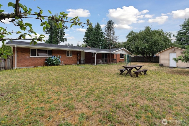 2598 25th Loop SE, Lacey, WA 98503 - rear view of property with brick siding, a fenced backyard, and a storage unit