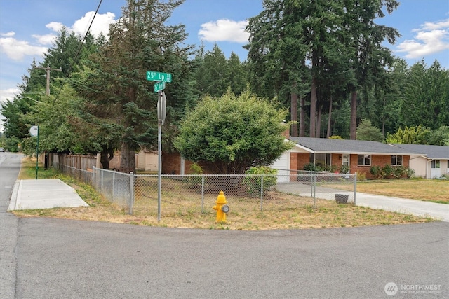 2598 25th Loop SE, Lacey, WA 98503 - view of front of house with concrete driveway, a fenced front yard, and a garage