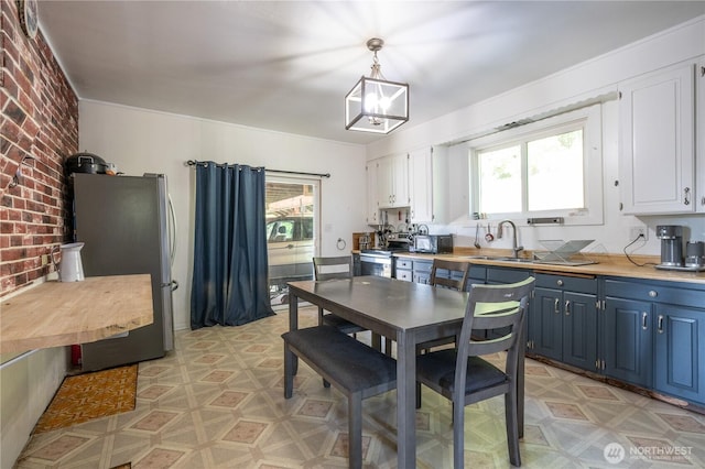1608 Laura St, Aberdeen, WA 98520 - dining space with plenty of natural light, brick wall, and light flooring