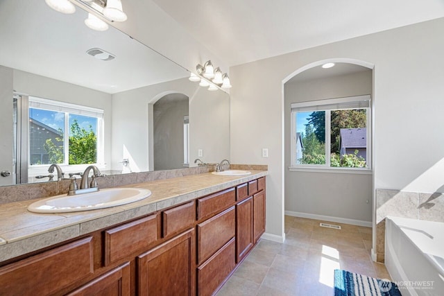 1326 SW 340th St, Federal Way, WA 98023 - bathroom featuring healthy amount of natural light, double vanity, a garden tub, and tile patterned floors