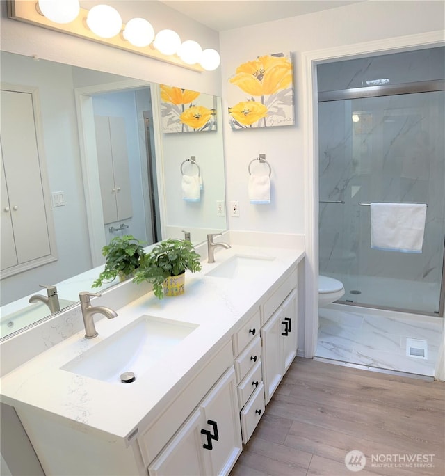 1711 159th Pl NE Unit 29, Bellevue, WA 98008 - full bathroom featuring double vanity, a marble finish shower, and wood finished floors