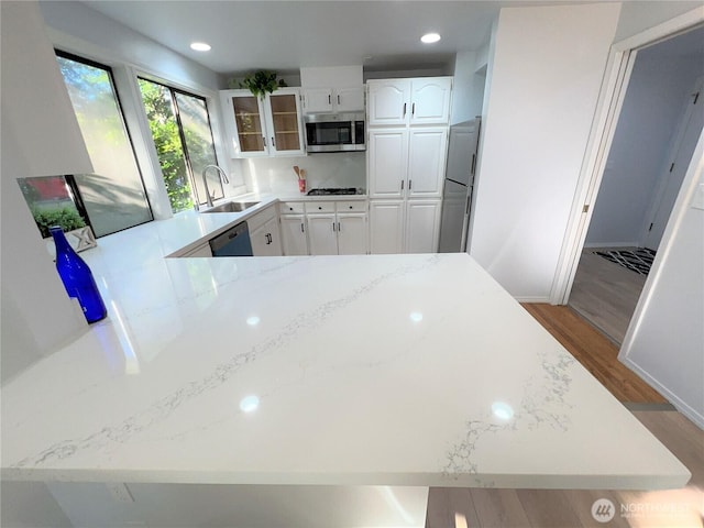 1711 159th Pl NE Unit 29, Bellevue, WA 98008 - kitchen featuring stainless steel microwave, fridge, dishwashing machine, light wood-type flooring, and white cabinets