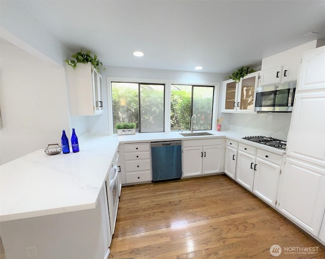 1711 159th Pl NE Unit 29, Bellevue, WA 98008 - kitchen featuring dishwashing machine, stainless steel microwave, gas cooktop, light wood-style floors, and recessed lighting