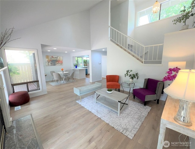 1711 159th Pl NE Unit 29, Bellevue, WA 98008 - living room featuring a high ceiling, wood finished floors, and stairway