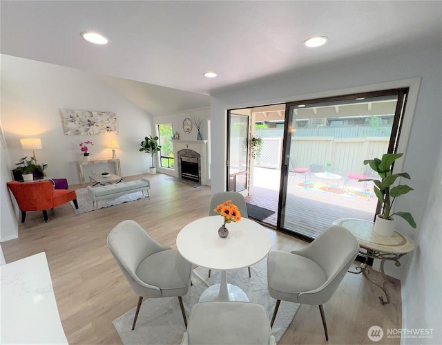 1711 159th Pl NE Unit 29, Bellevue, WA 98008 - living room featuring light wood-style floors, lofted ceiling, a fireplace with flush hearth, and recessed lighting