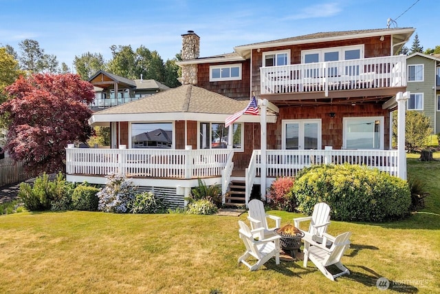 6926 Holeman Ave, Blaine, WA 98230 - back of house with a chimney, a fire pit, a yard, and roof with shingles