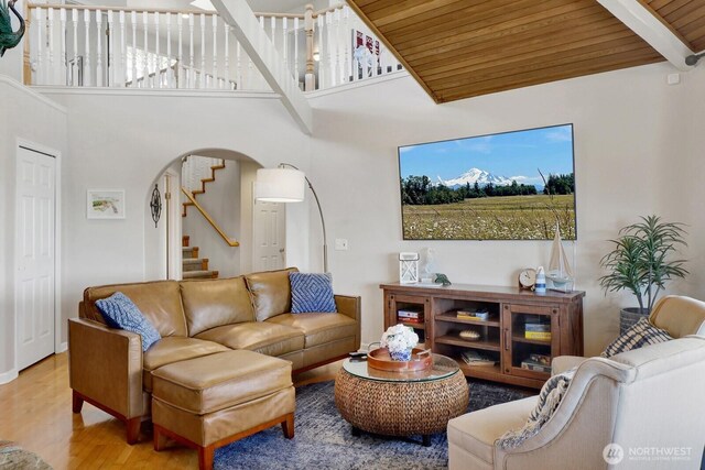 6926 Holeman Ave, Blaine, WA 98230 - living area with wood finished floors, stairway, arched walkways, a towering ceiling, and wooden ceiling