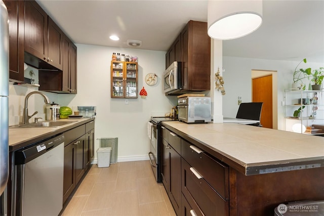 7343 35th SW, Seattle, WA 98126 - kitchen featuring stainless steel appliances, dark brown cabinets, a peninsula, and recessed lighting