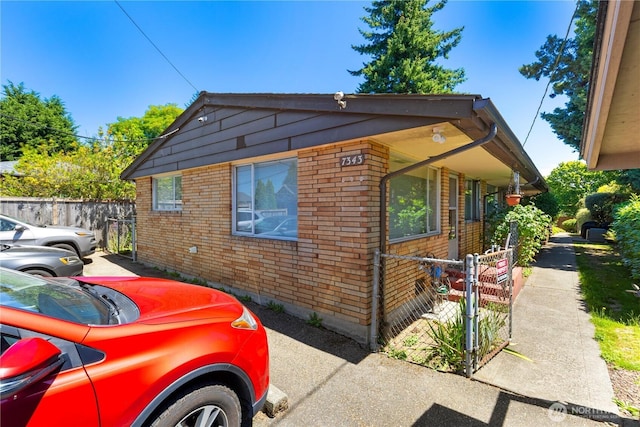 7343 35th SW, Seattle, WA 98126 - view of home's exterior featuring brick siding and a gate