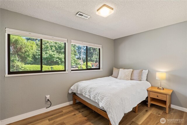 4502 223rd St SW, Mountlake Terrace, WA 98043 - bedroom featuring wood finished floors and a textured ceiling