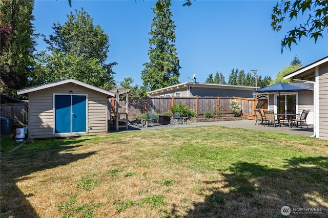 4502 223rd St SW, Mountlake Terrace, WA 98043 - fenced backyard featuring a patio area and a storage shed