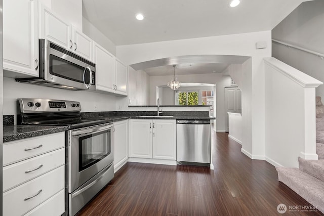 23218 62nd Ave S Unit 21-4, Kent, WA 98032 - kitchen featuring stainless steel appliances, a peninsula, a chandelier, white cabinets, and dark wood-style flooring