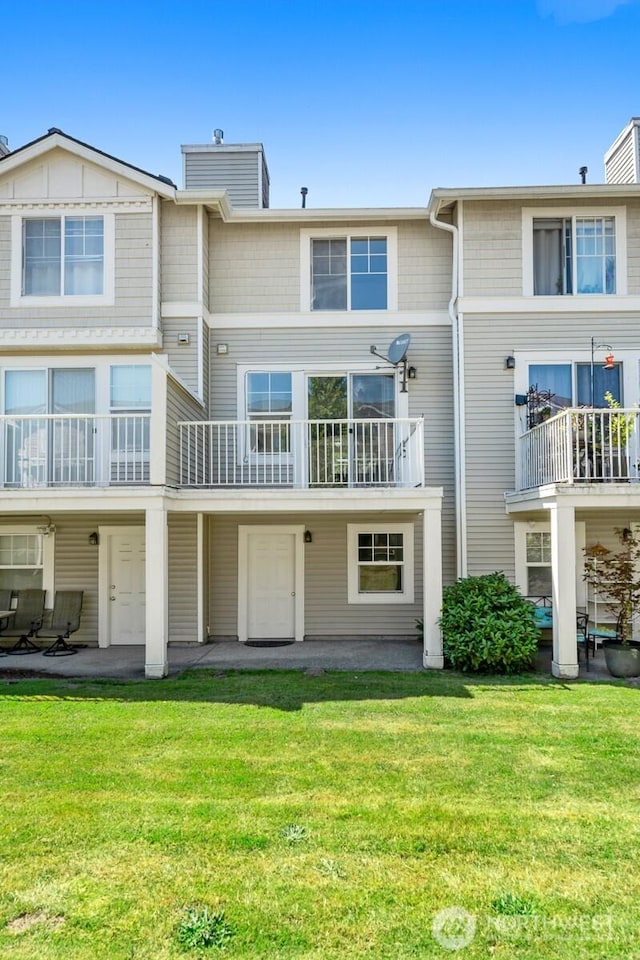 23218 62nd Ave S Unit 21-4, Kent, WA 98032 - back of property featuring a chimney, a lawn, a patio, and a balcony
