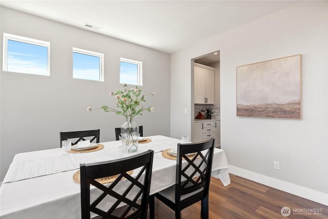 381 E Benson Ridge Rd, Grapeview, WA 98546 - dining area featuring dark wood-style flooring and baseboards