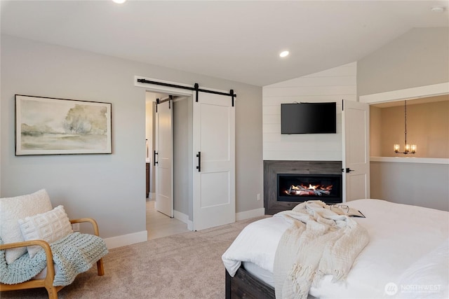 381 E Benson Ridge Rd, Grapeview, WA 98546 - bedroom featuring lofted ceiling, light colored carpet, a barn door, recessed lighting, and a glass covered fireplace