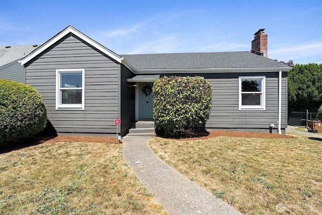 213 S 58th St, Tacoma, WA 98408 - bungalow featuring a front lawn, a chimney, and a shingled roof
