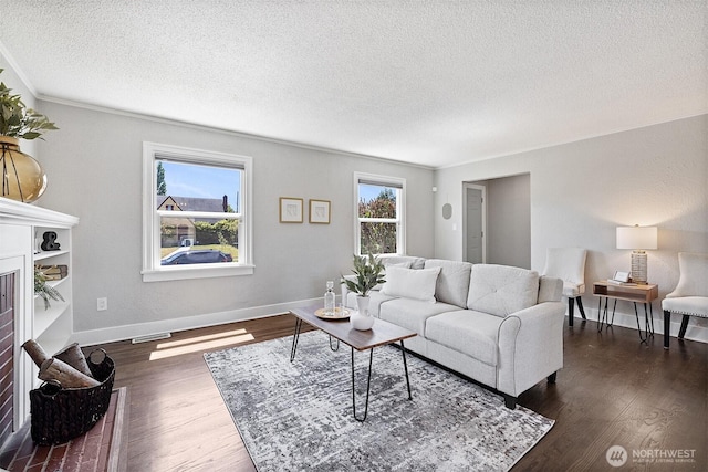 213 S 58th St, Tacoma, WA 98408 - living room featuring a fireplace, a textured ceiling, and dark wood-style floors