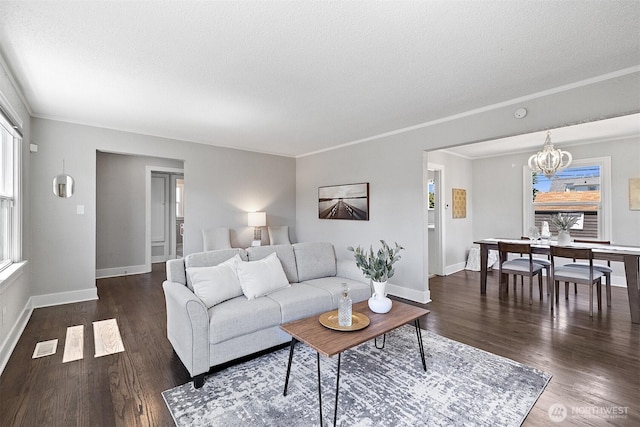 213 S 58th St, Tacoma, WA 98408 - living area with a textured ceiling, a chandelier, healthy amount of natural light, dark wood-type flooring, and crown molding