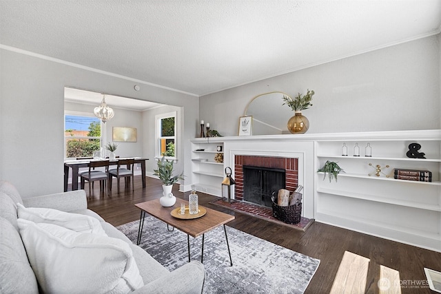 213 S 58th St, Tacoma, WA 98408 - living area featuring wood finished floors, a chandelier, ornamental molding, a brick fireplace, and a textured ceiling