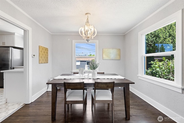 213 S 58th St, Tacoma, WA 98408 - dining area featuring a chandelier, plenty of natural light, ornamental molding, a textured ceiling, and dark wood-type flooring