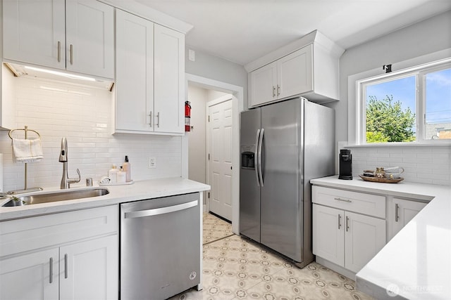 213 S 58th St, Tacoma, WA 98408 - kitchen featuring appliances with stainless steel finishes, decorative backsplash, white cabinetry, and light countertops