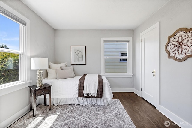 213 S 58th St, Tacoma, WA 98408 - bedroom featuring dark wood-style flooring and baseboards