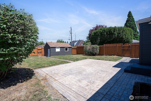 213 S 58th St, Tacoma, WA 98408 - fenced backyard with a patio, a gate, and an outbuilding