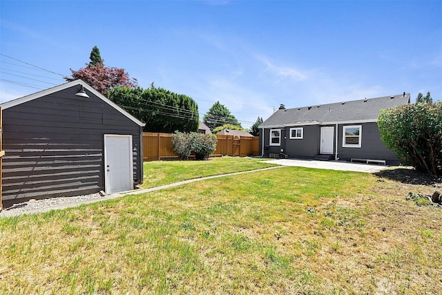 213 S 58th St, Tacoma, WA 98408 - fenced backyard featuring a patio and a storage shed