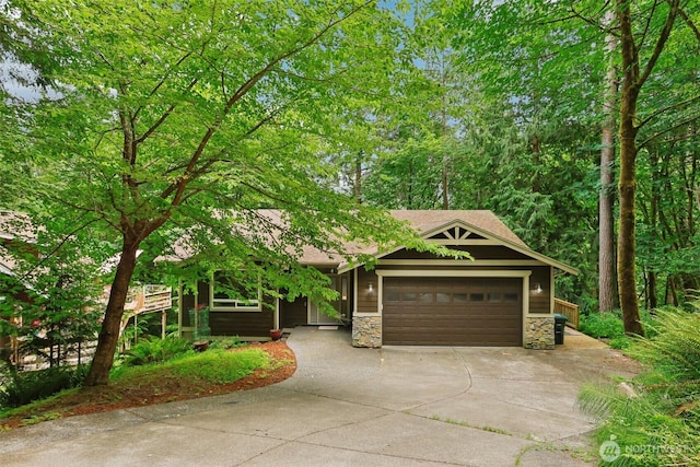 49 Cascade Ln, Bellingham, WA 98229 - view of front of house featuring stone siding, concrete driveway, a garage, and roof with shingles