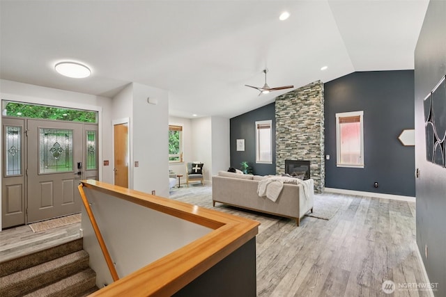 49 Cascade Ln, Bellingham, WA 98229 - foyer entrance with vaulted ceiling, a ceiling fan, light wood finished floors, and a fireplace