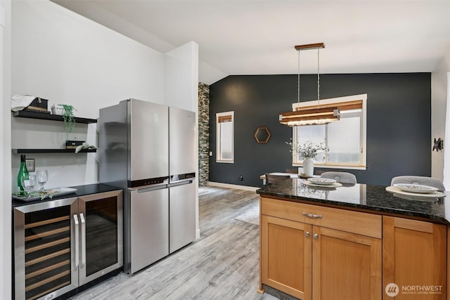 49 Cascade Ln, Bellingham, WA 98229 - kitchen featuring vaulted ceiling, beverage cooler, freestanding refrigerator, light wood finished floors, and dark stone counters