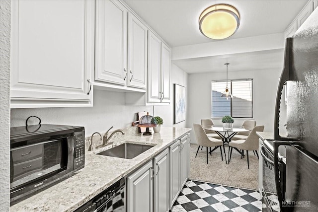 700 N 160th St Unit A316, Shoreline, WA 98133 - kitchen with freestanding refrigerator, black microwave, white cabinets, light stone counters, and tile patterned floors