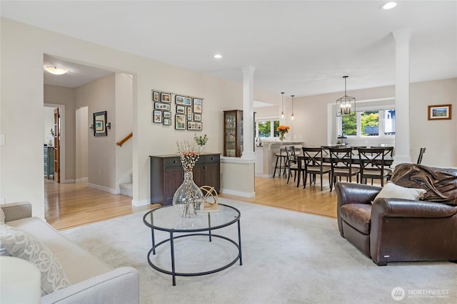 7709 NE 170th St, Kenmore, WA 98028 - living room featuring recessed lighting, stairway, light wood finished floors, a chandelier, and light colored carpet
